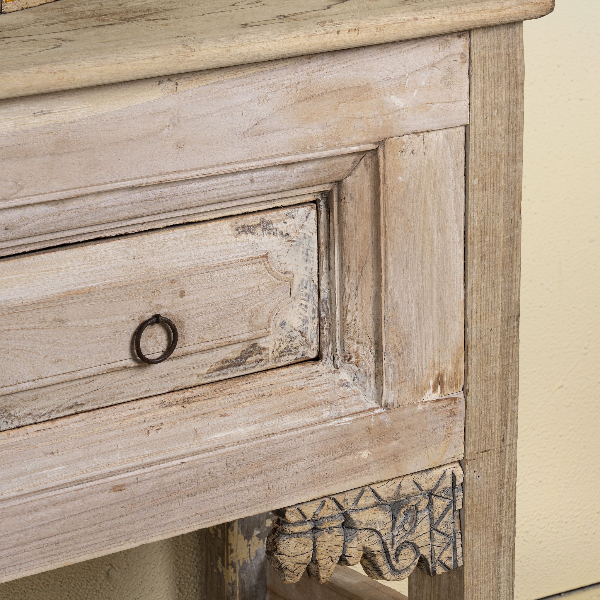 Close-up of a teak wood console table with two drawers, carved leg details, and sanded reclaimed finish, 223 × 45 × 83 cm.
