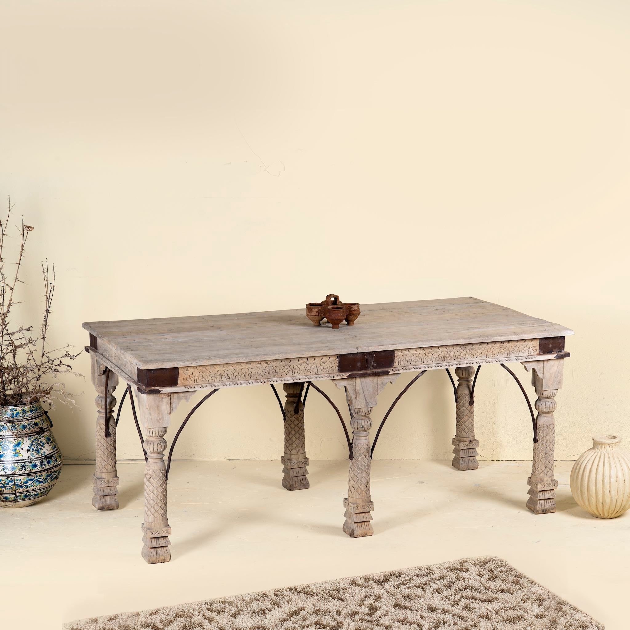 Teak wood dining table with six hand-carved pillar legs; reclaimed Indian dining table, 180 × 90 × 75 cm.