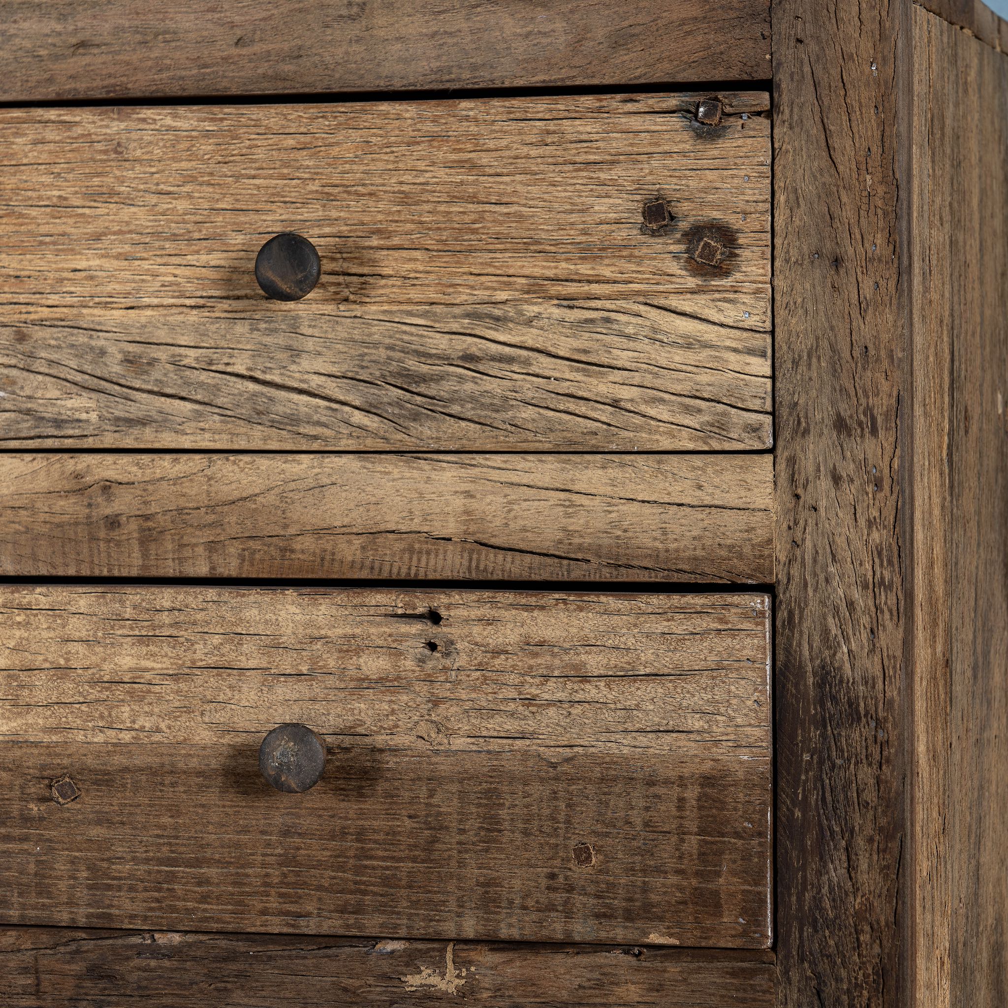 Close up image of a tall bathroom cabinet made from reclaimed wood with six drawers and rustic finish, 50 × 35 × 110 cm.
