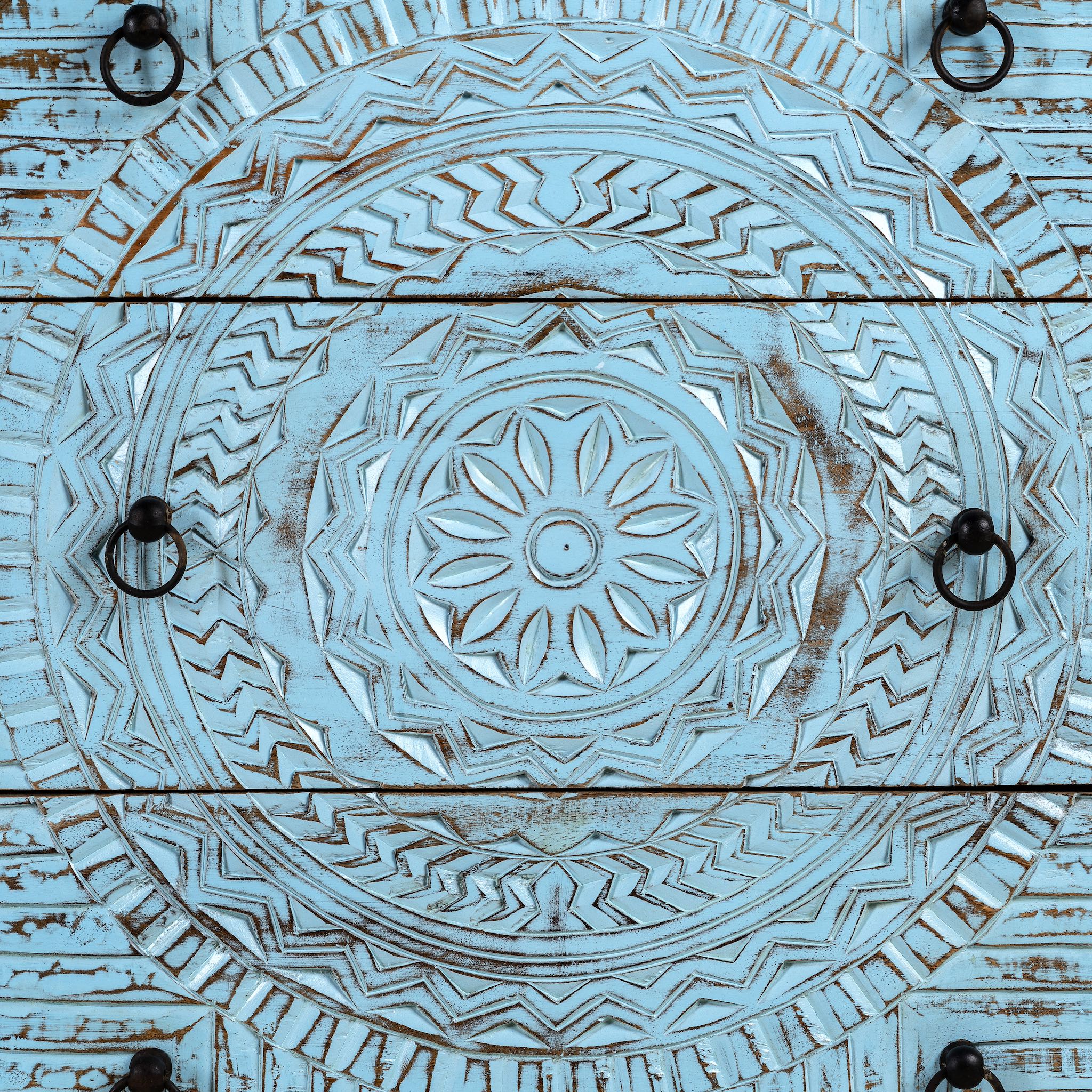 Close up image of a hand-carved mango wood chest of drawers Safita with distressed blue finish and iron fittings, boho style living room furniture, 140 × 42 × 100 cm.