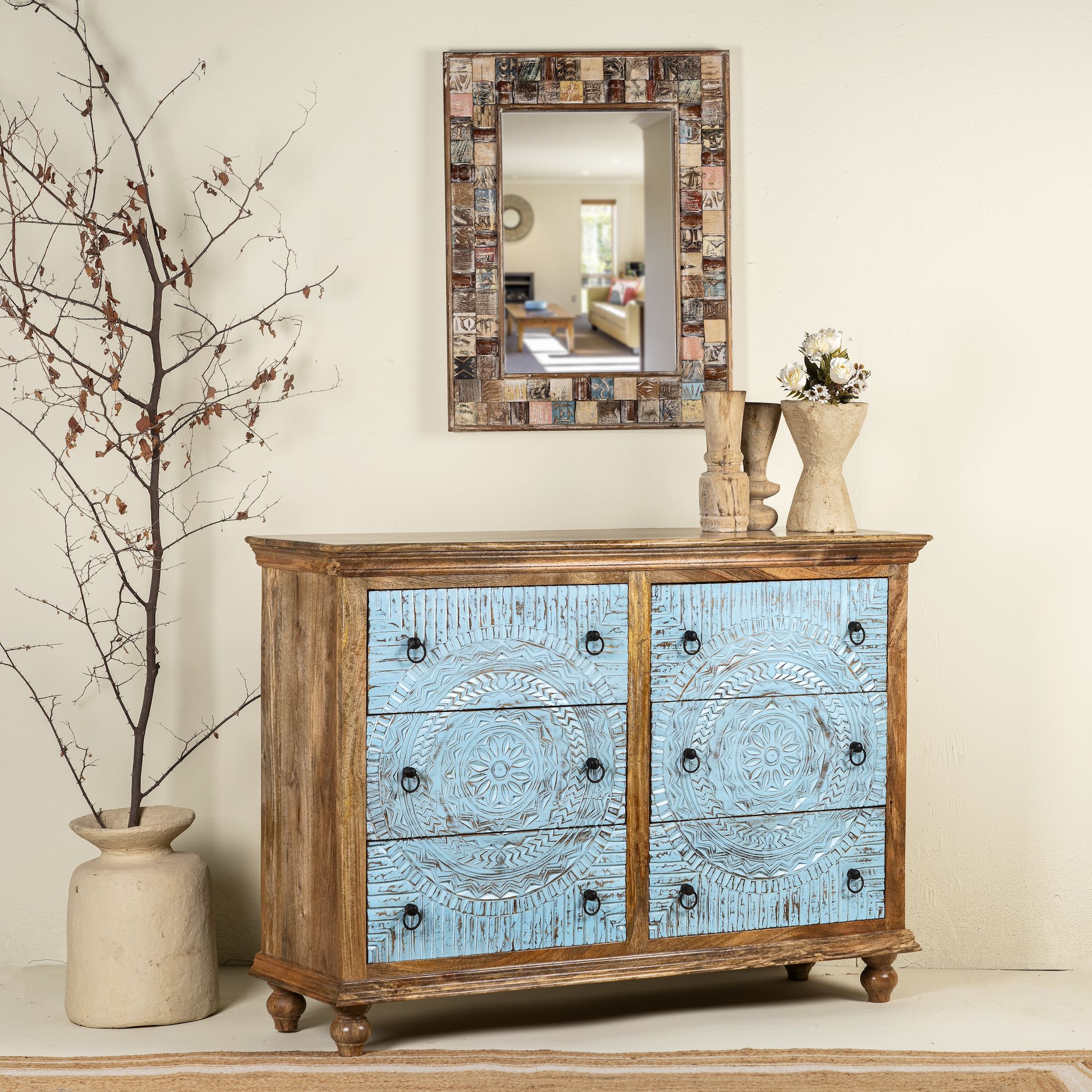 Side angle image of a hand-carved mango wood chest of drawers Safita with distressed blue finish and iron fittings, boho style living room furniture, 140 × 42 × 100 cm.