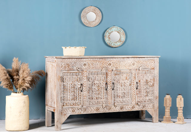 Side angle image of a hand-carved mango wood sideboard with a three-layer vintage finish, featuring two doors and three drawers—perfect for rustic or bohemian interiors.