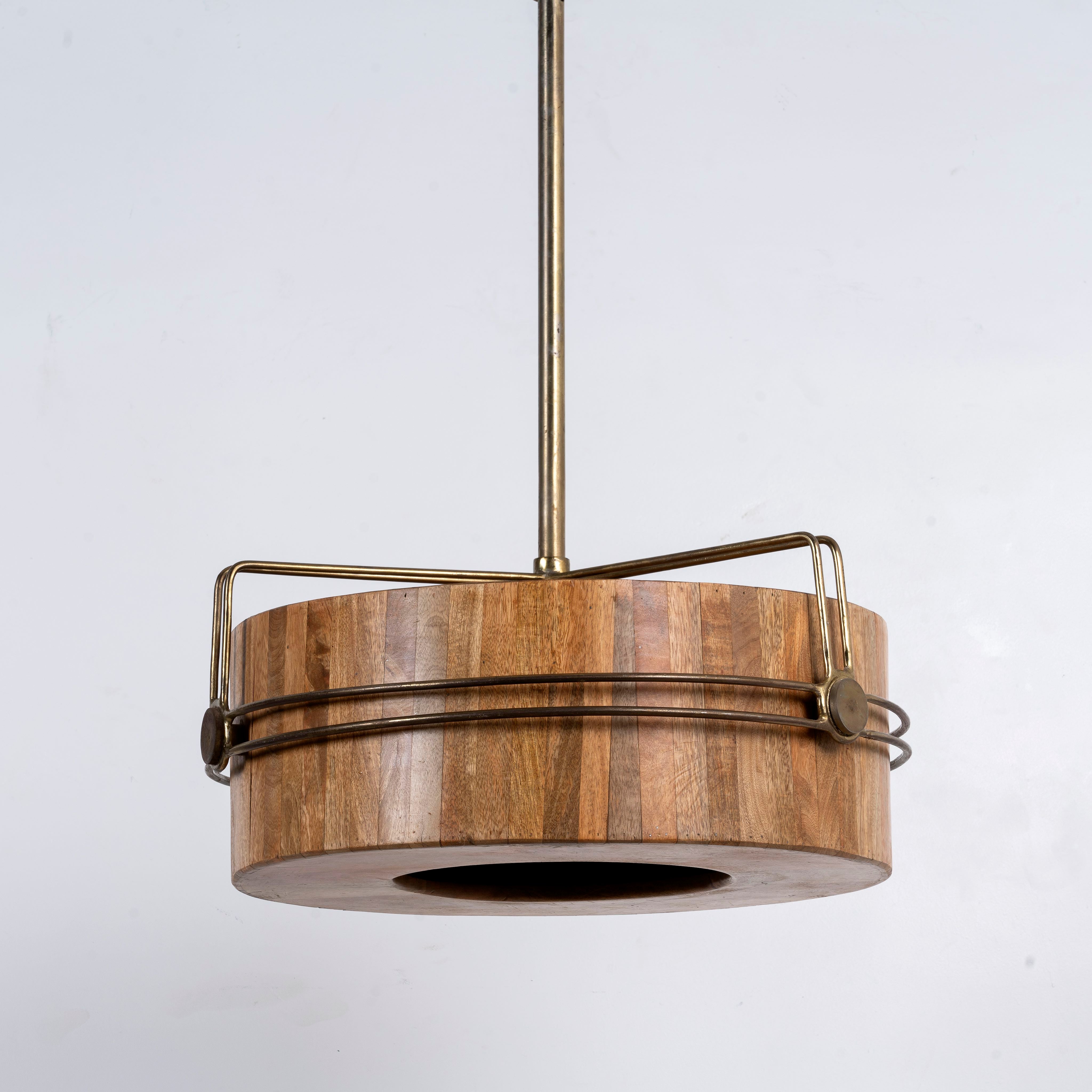 Side angle image of a rustic single light pendant lamp with Mango wood and antique brass iron frame – minimalistic style lighting ideal for dining tables, kitchen islands, or cozy living areas.