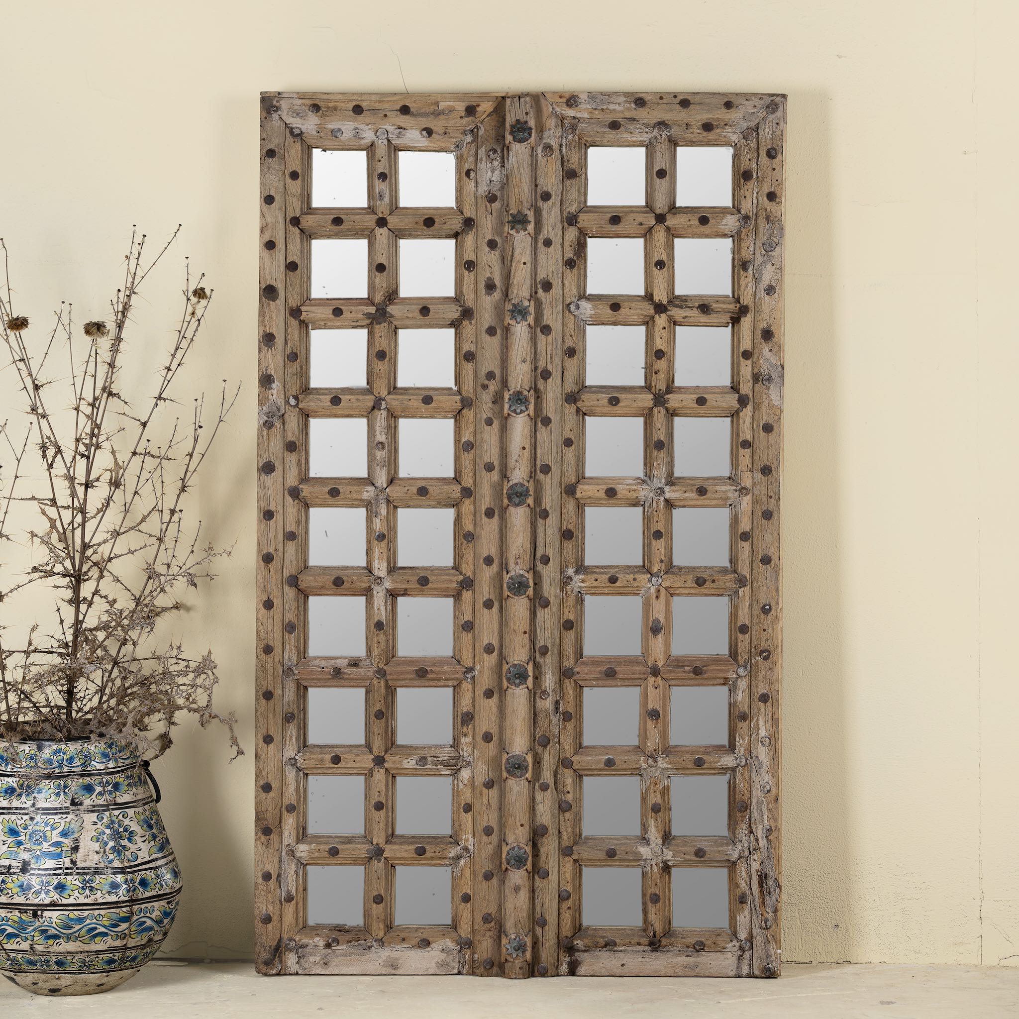 Soma wooden door mirror made from antique teak, part of our Indian home decor collection with original carvings and iron accents.