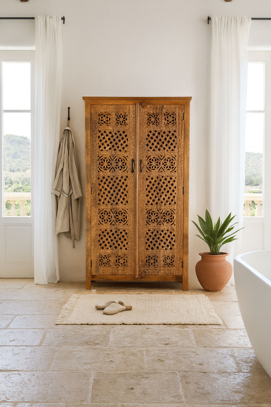 Lifestyle scene with a hand-carved mango wood wardrobe with floral and lattice motifs – a detailed piece of carved wood furniture ideal for natural mango wood interiors.