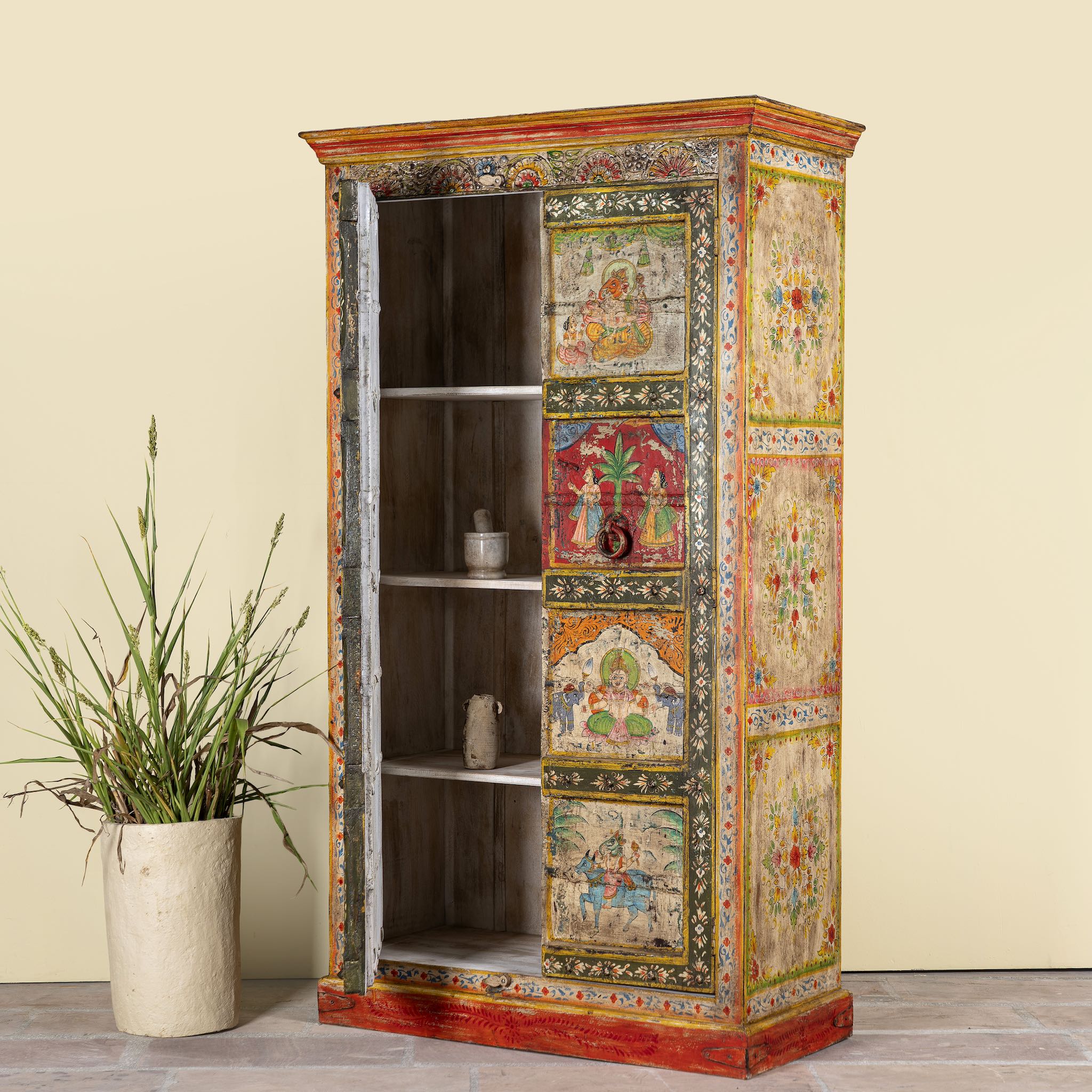 Open door image of a hand painted teak wood cabinet with floral motifs, restored Indian furniture online; unique storage piece, 100 × 44 × 185 cm.