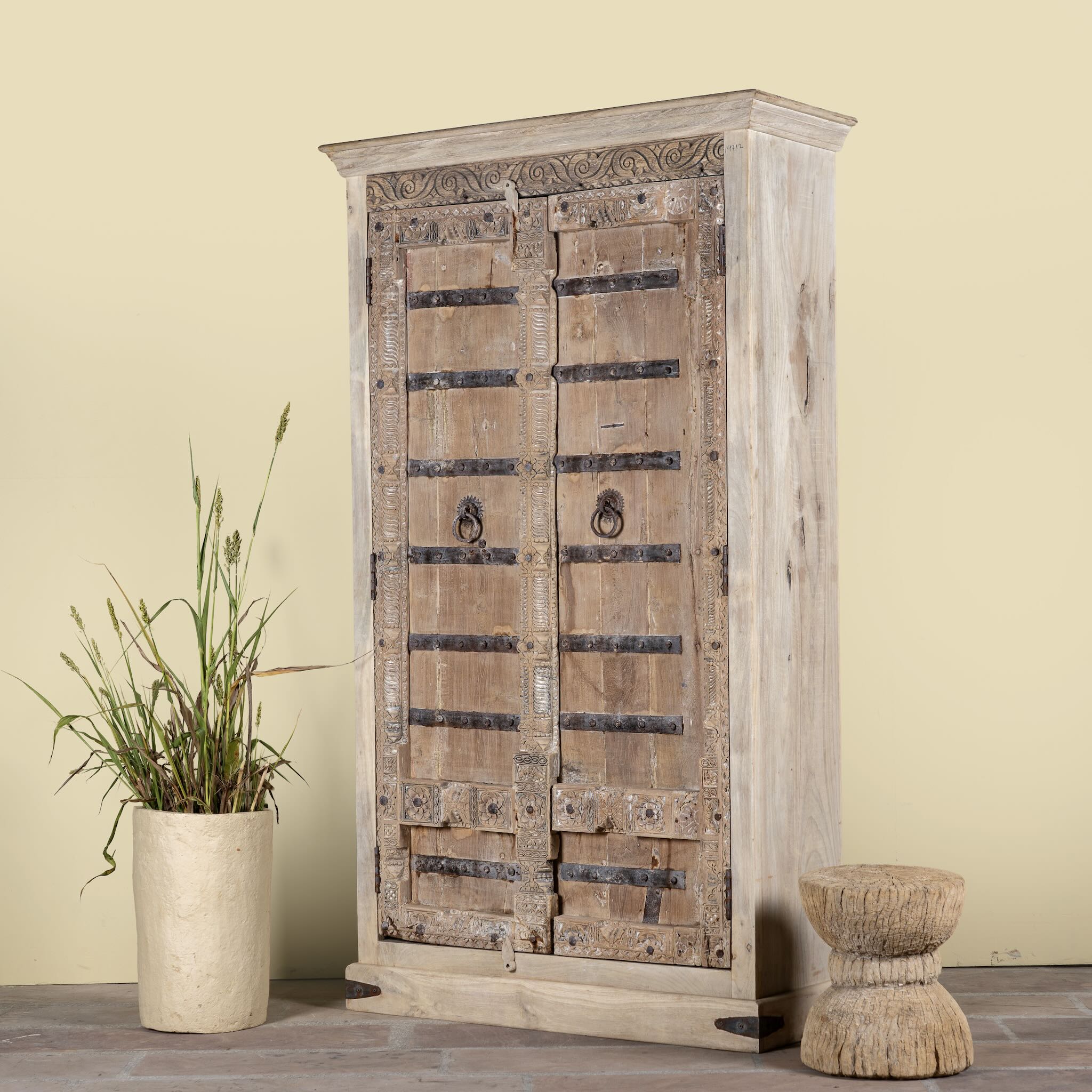 Side angle image of a hand-carved teak wood wardrobe with original iron fittings – Veena model by Om Home & Garden
