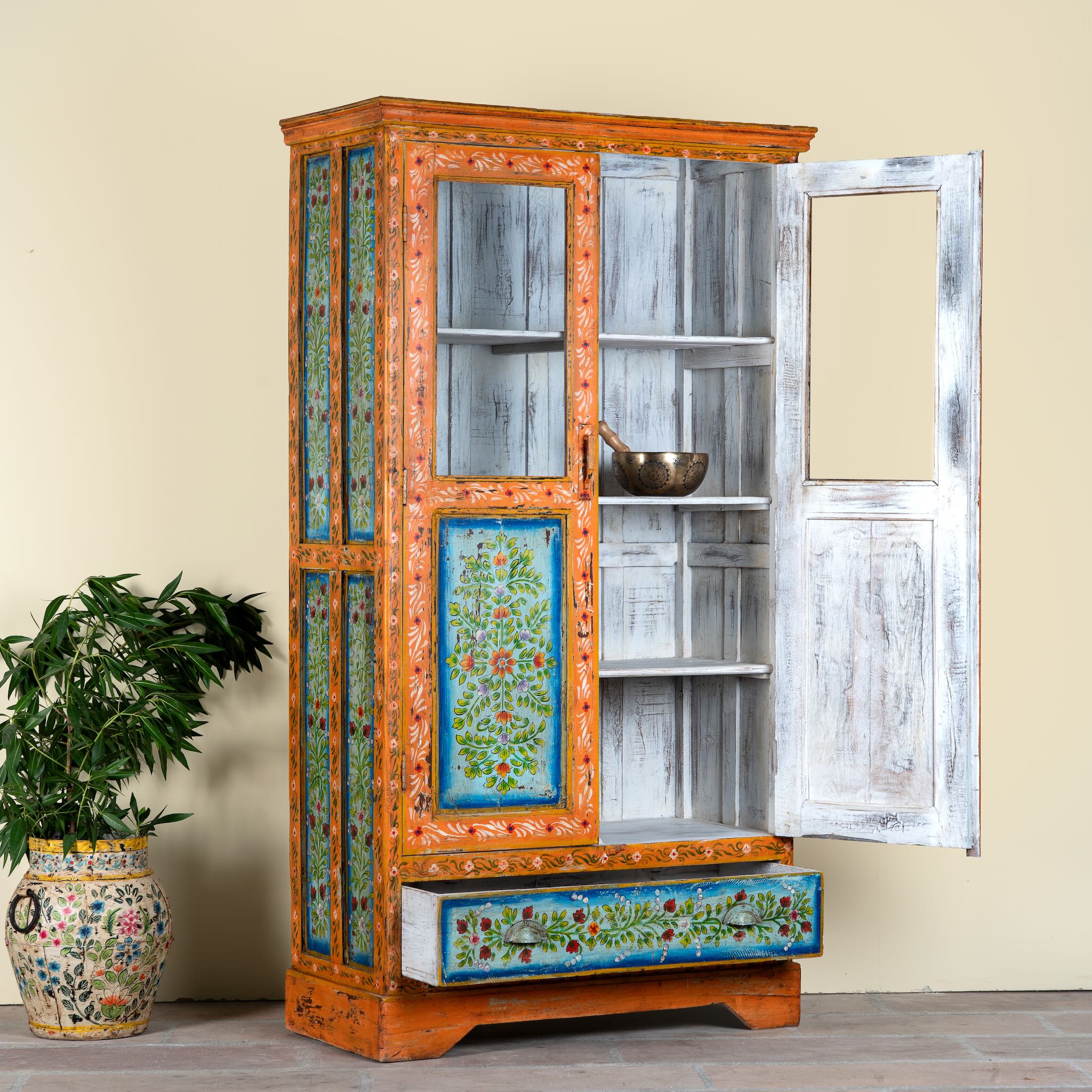 Side angle image with open door of a hand painted reclaimed wood showcase with 2 doors and one drawer.