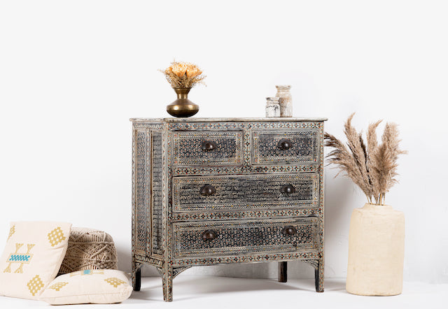Side angle image of a hand-painted Indian chest of drawers made from recycled wood – unique furniture featuring colourful motifs and antique craftsmanship.