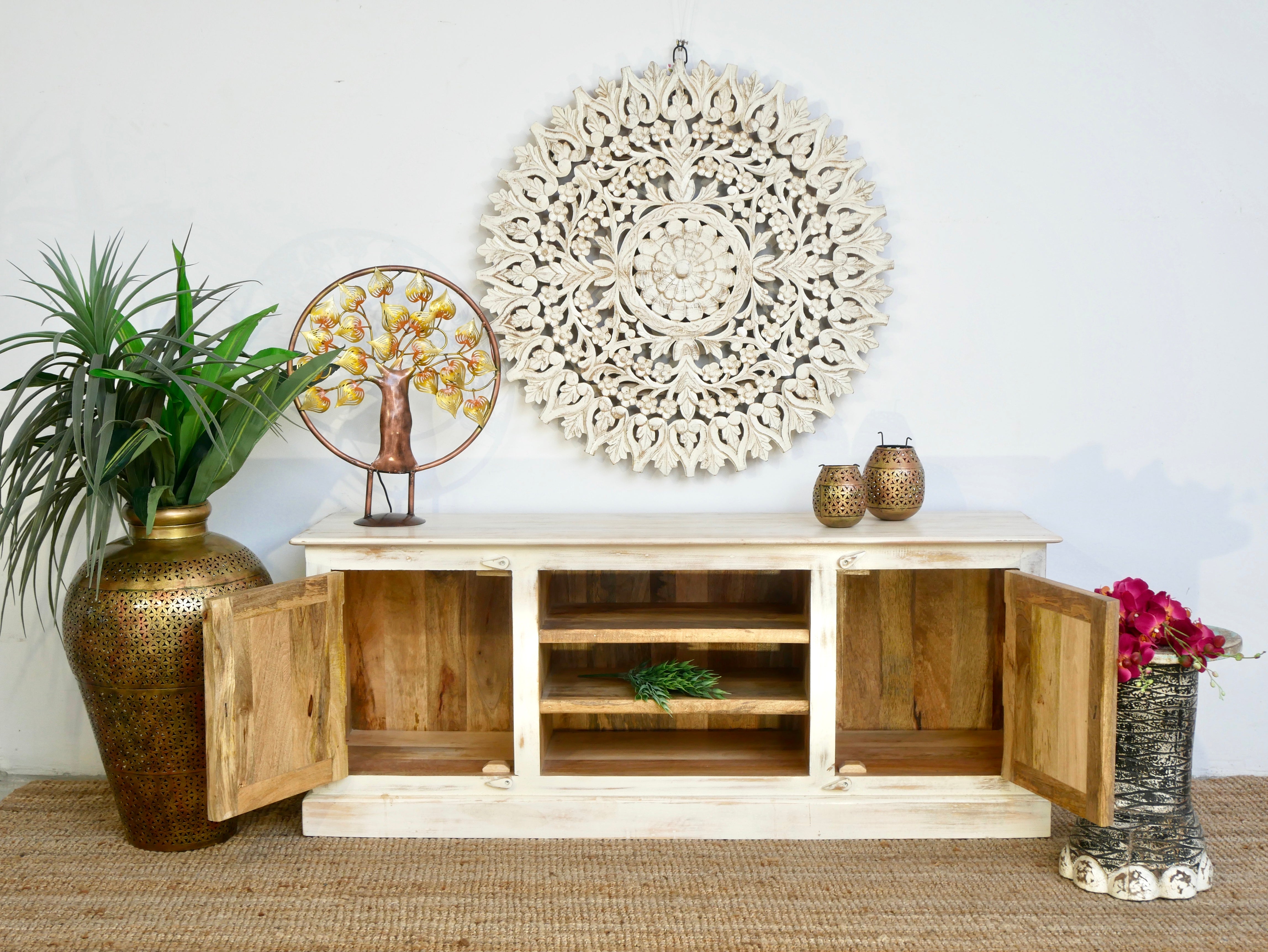 Open door image of a hand carved lowboard made from mango wood with floral doors and open compartments; wooden TV unit, 150 × 60 × 40 cm.