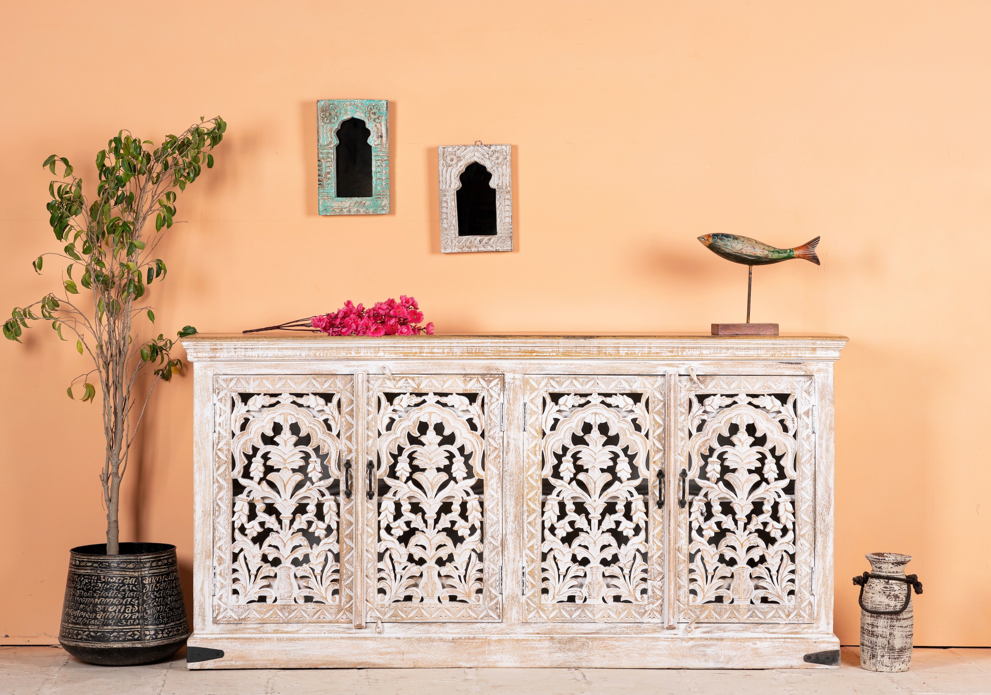 Hand-carved whitewashed mango wood sideboard with intricate floral detailing, perfect for a boho chic living room or vintage-inspired interior.