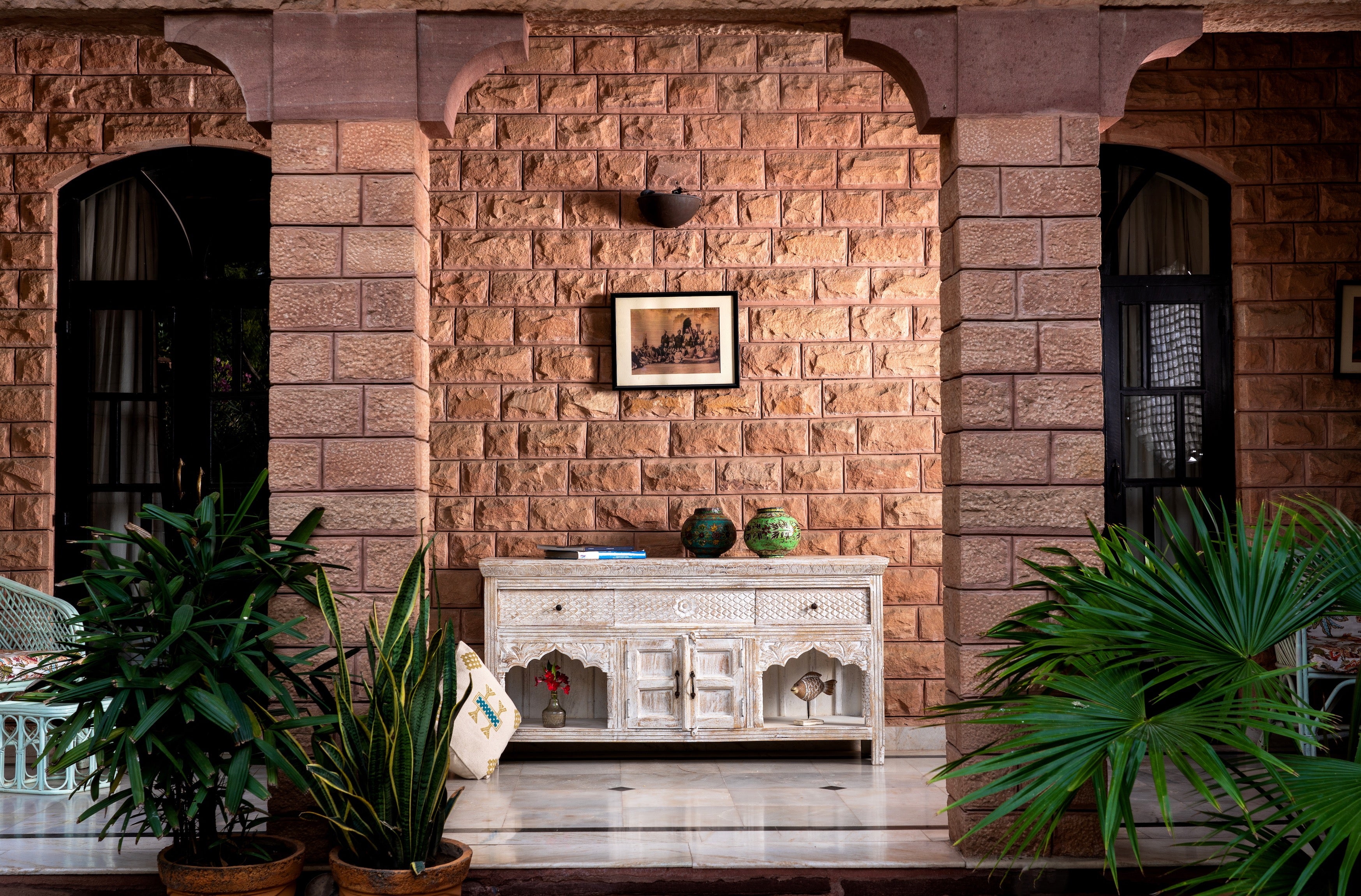 Life style image of a Hand-carved console table in mango wood with whitewashed finish, perfect for a bohemian interior.