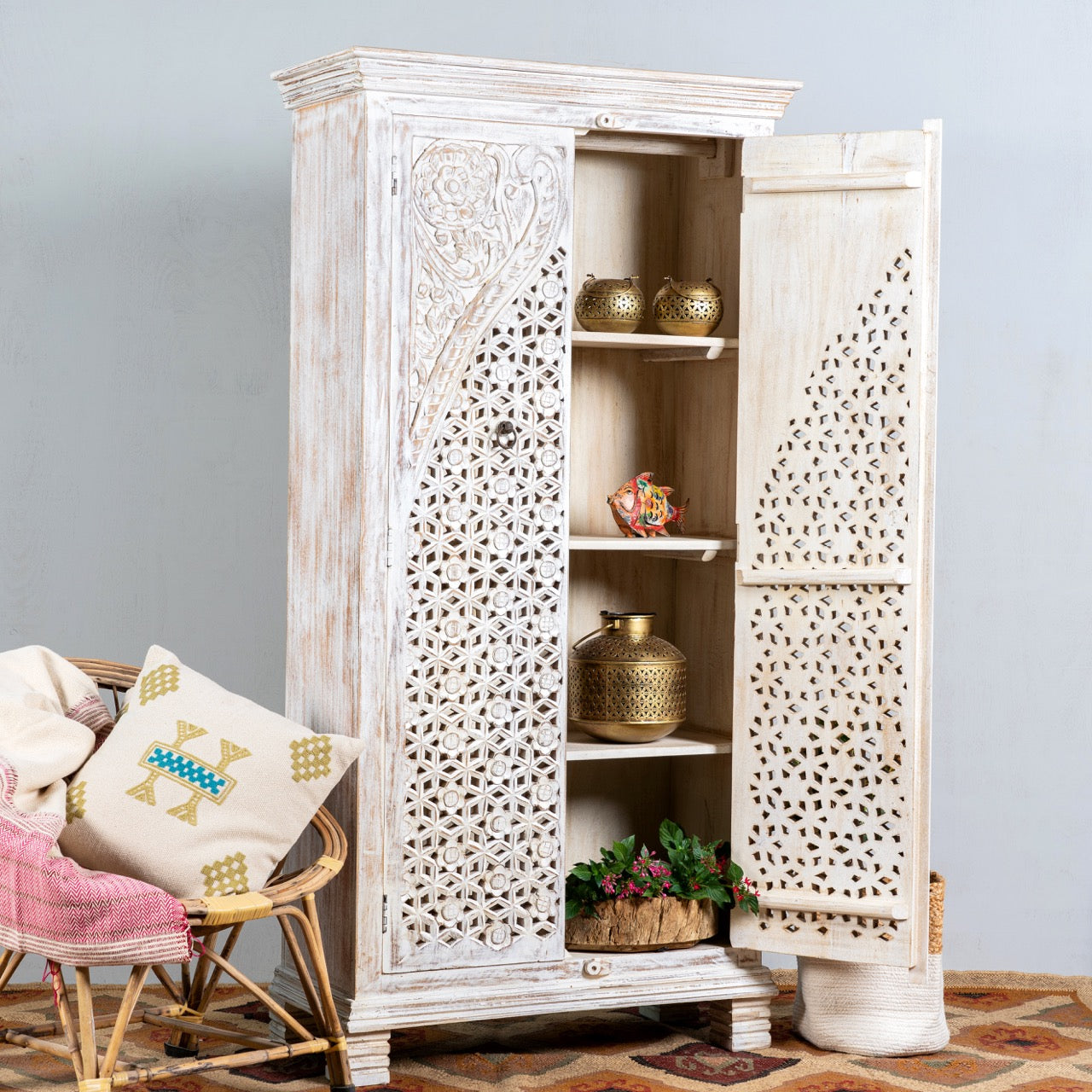 Open door image of a white-washed hand-carved wooden wardrobe made of solid mango wood, vintage furniture with Mediterranean Ibiza style, 180 × 90 × 40 cm.