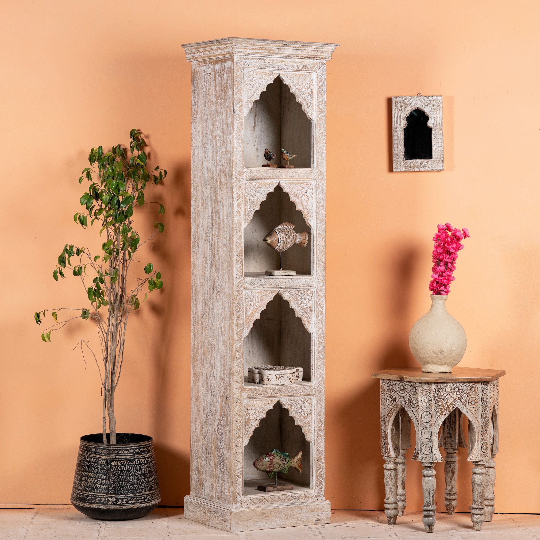 Side angle, decorated image of a hand-carved mango wood bookshelf with oriental detailing and natural wood finish – carved wooden furniture and vertical shelving for refined, rustic interiors.