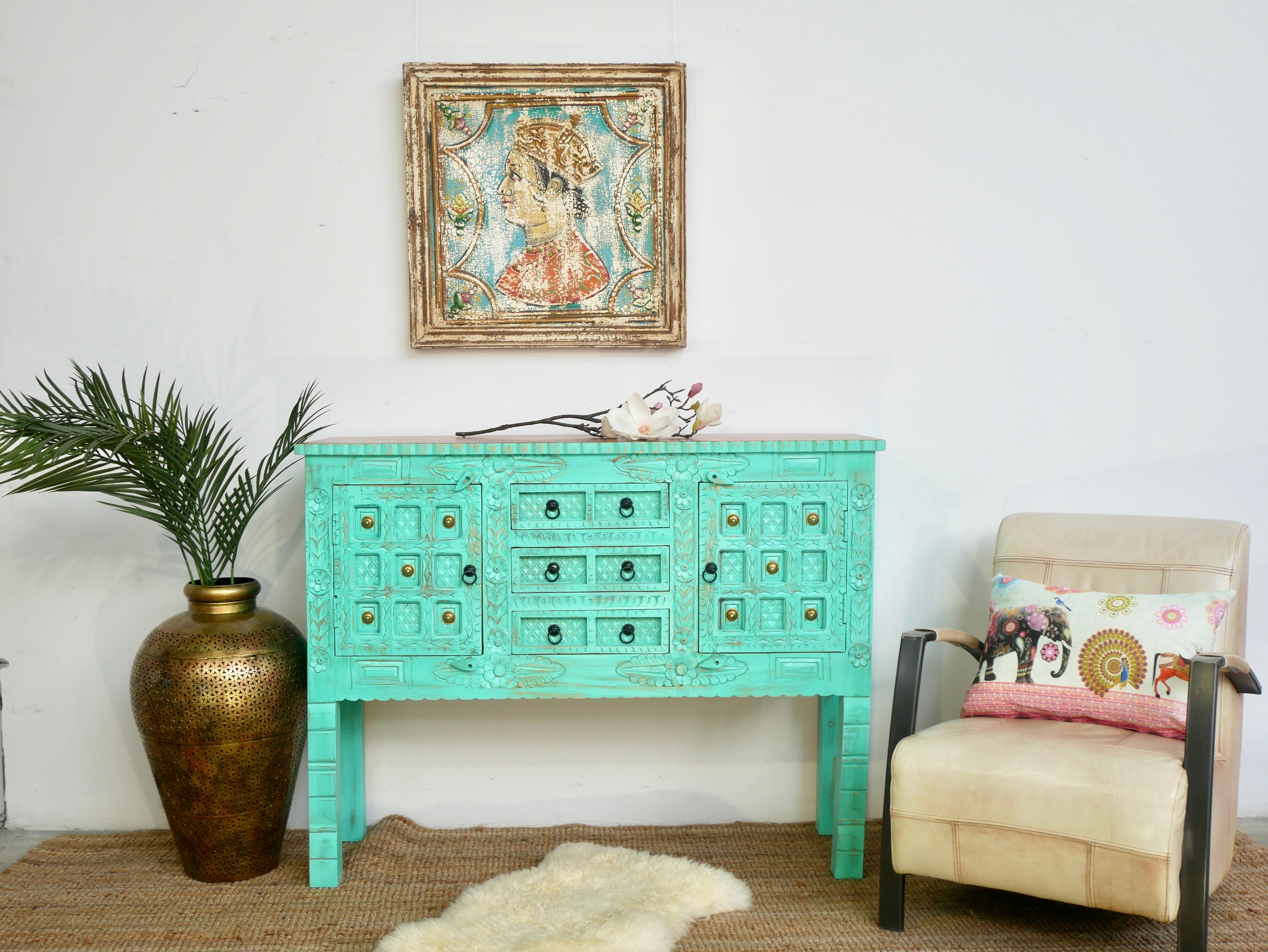 Green storage console table with carved mango wood doors and brass details; mango wood console table, 130 × 100 × 40 cm.