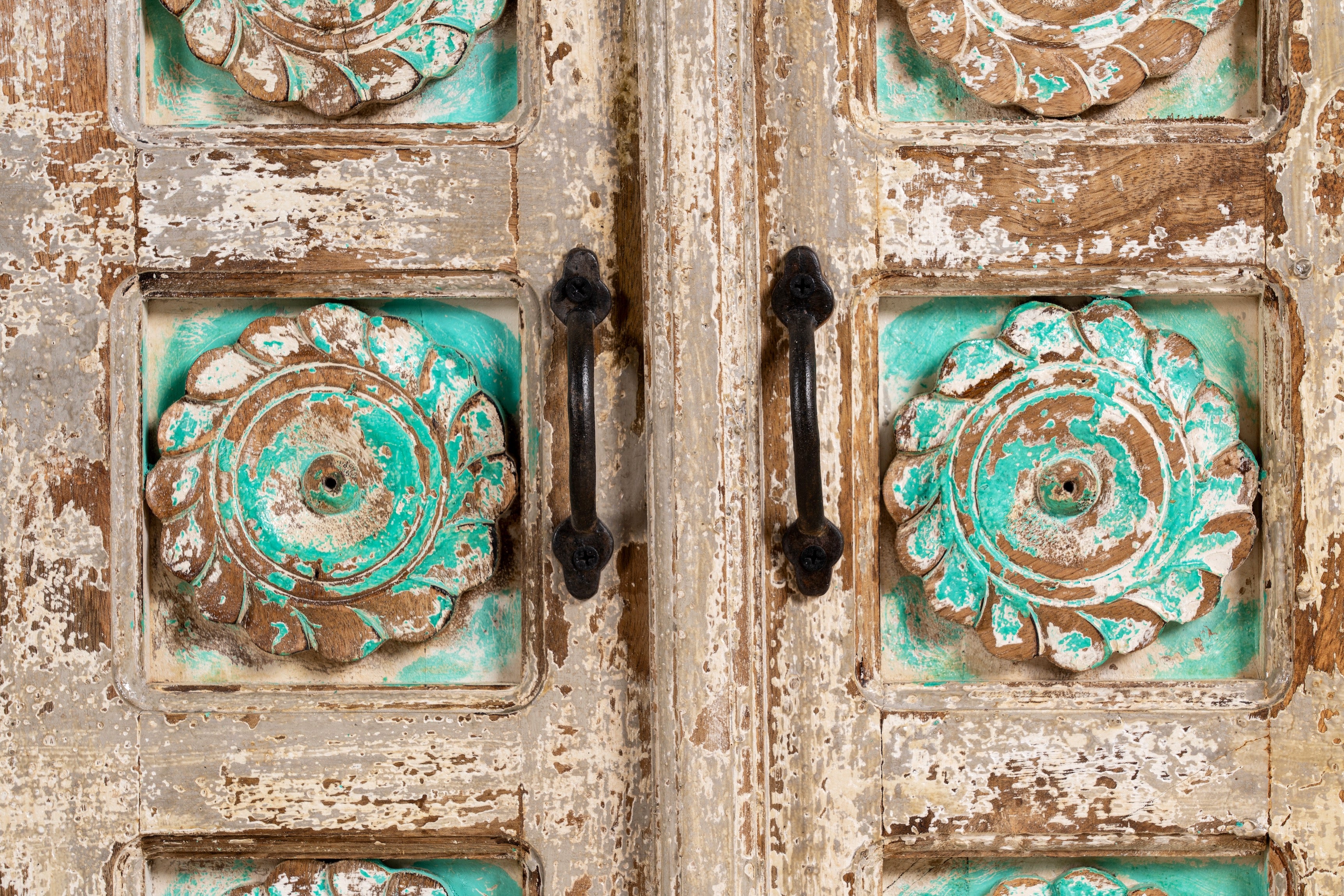 Close up image of a hand-carved mango wood sideboard with green floral accents and vintage finish; perfect for bedroom furniture and bohemian interior style, 180 × 100 × 40 cm.