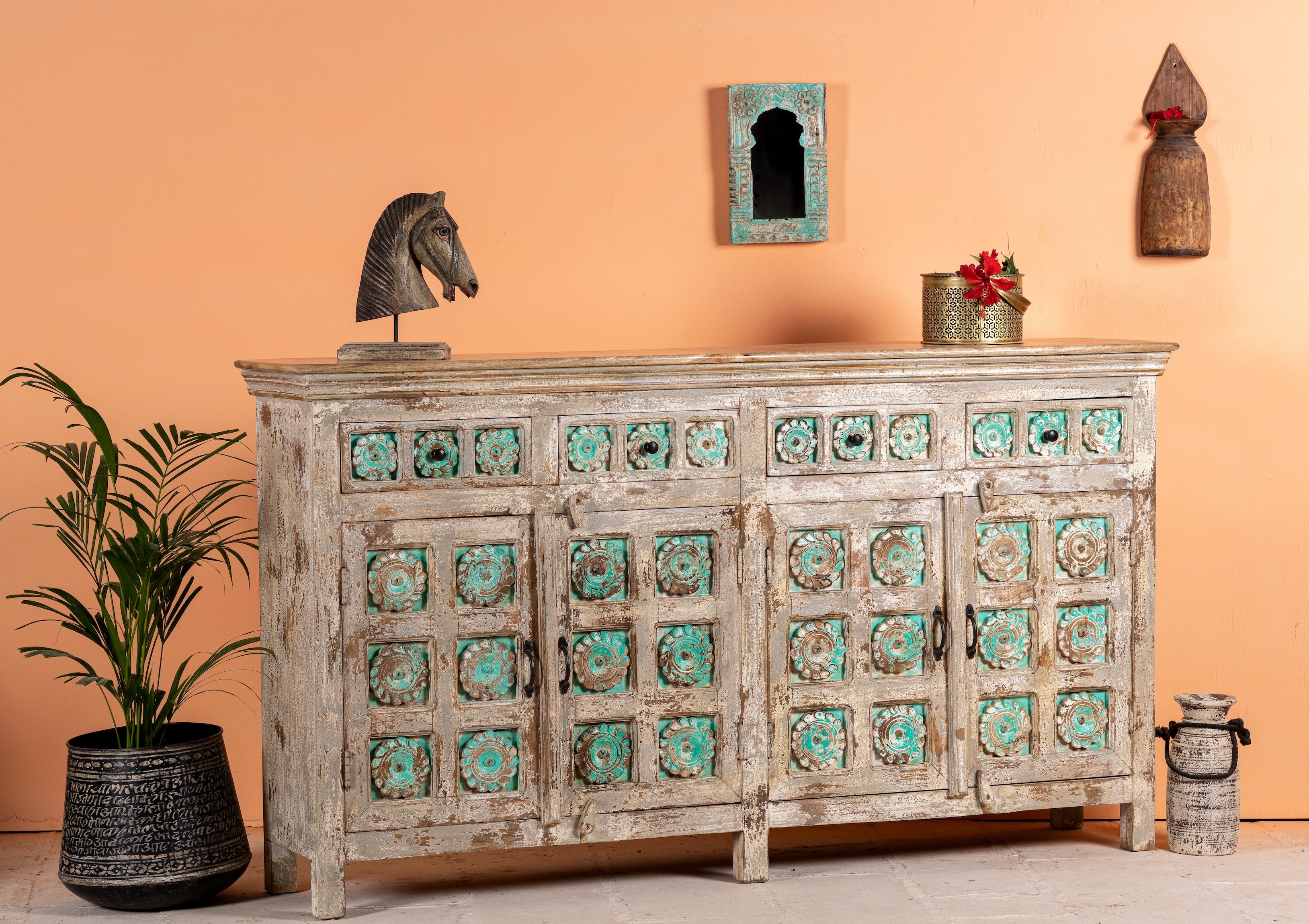 Side angle image of a hand-carved mango wood sideboard with green floral accents and vintage finish; perfect for bedroom furniture and bohemian interior style, 180 × 100 × 40 cm.