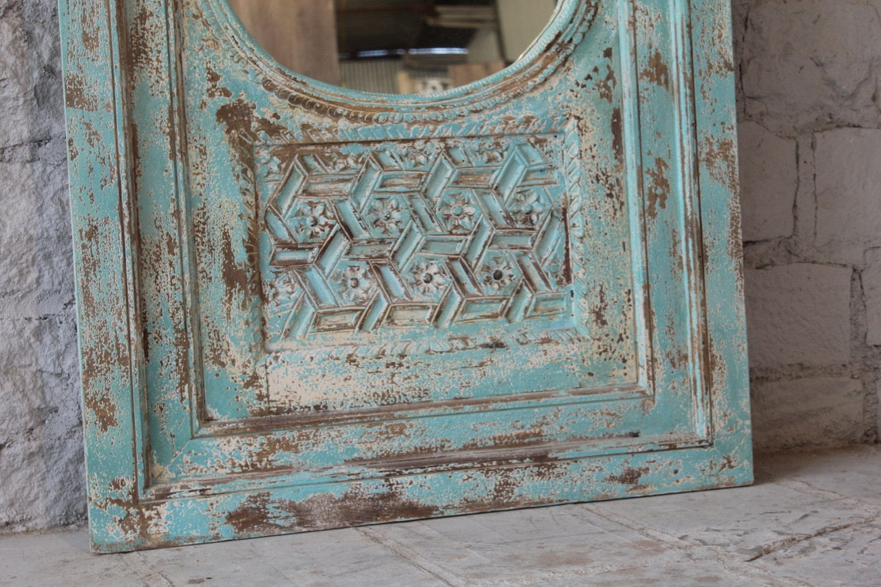 Close up image of a tall vintage wall mirror with hand-carved mango wood frame; rustic hand carved mirror, 86 × 160 × 5 cm.