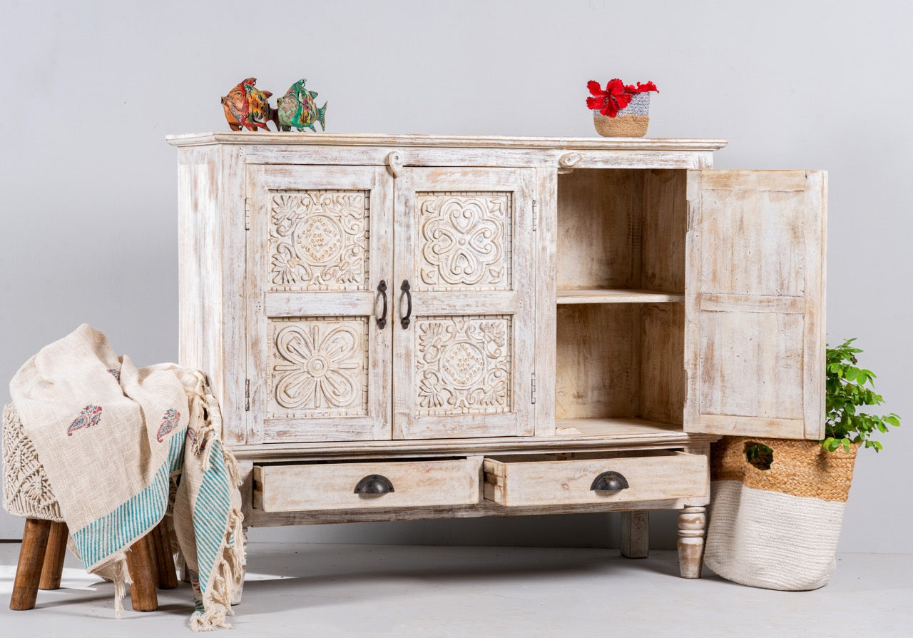 Open door image of a whitewashed hand carved wooden sideboard made from solid mango wood with floral patterns, 3 doors and 2 drawers; artisanal mango wood furniture, 120 × 100 × 40 cm.