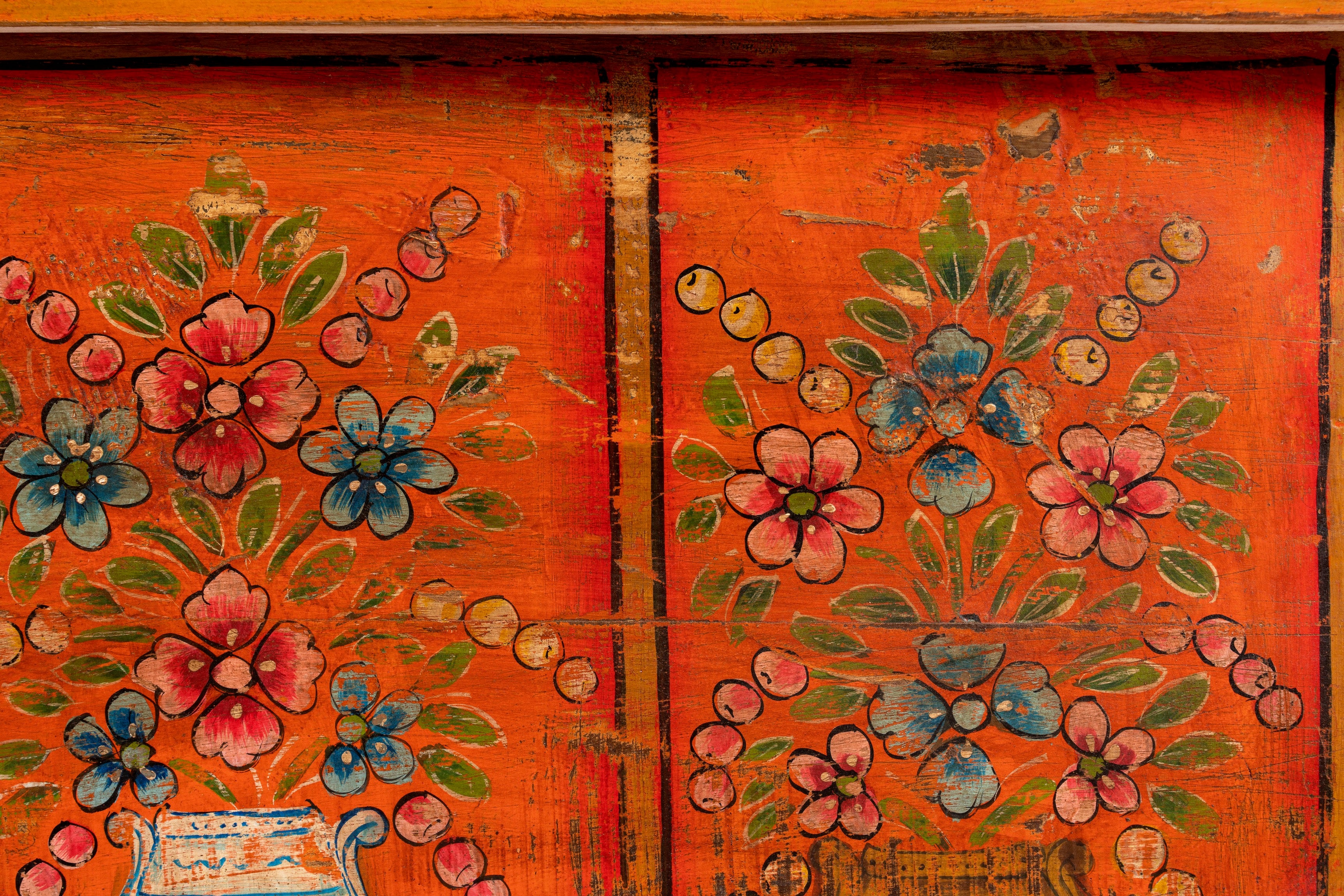 Close up image of a hand-painted teak reclaimed wood chest – sustainable handcrafted furniture serving as a coffee table and artistic storage solution.