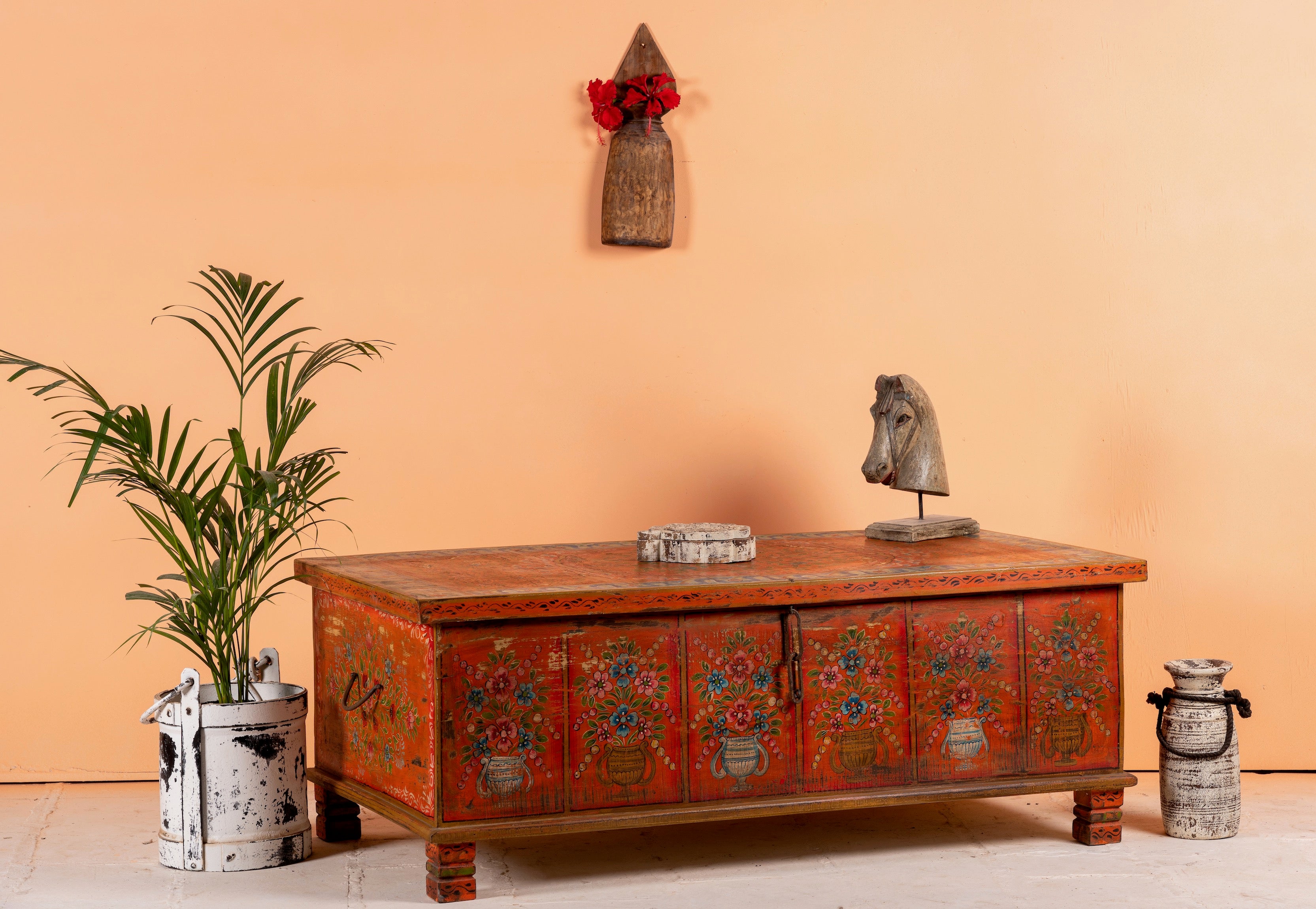 Side angle image of a hand-painted teak reclaimed wood chest – sustainable handcrafted furniture serving as a coffee table and artistic storage solution.