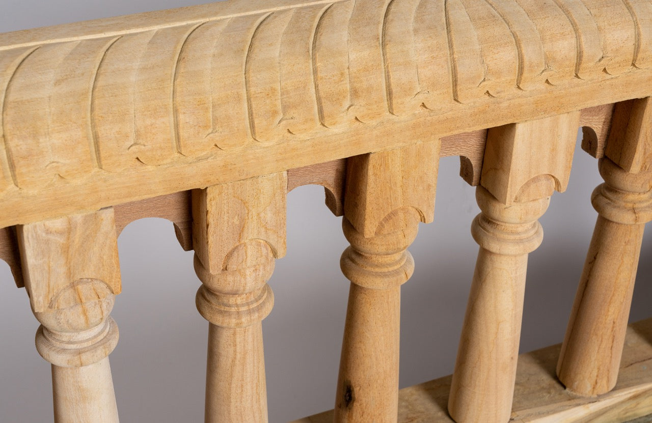 Close up image of a reclaimed teak wood bench with horse-head carvings and hidden storage; sustainable double-seater with cushion, 150 × 93 × 77 cm.