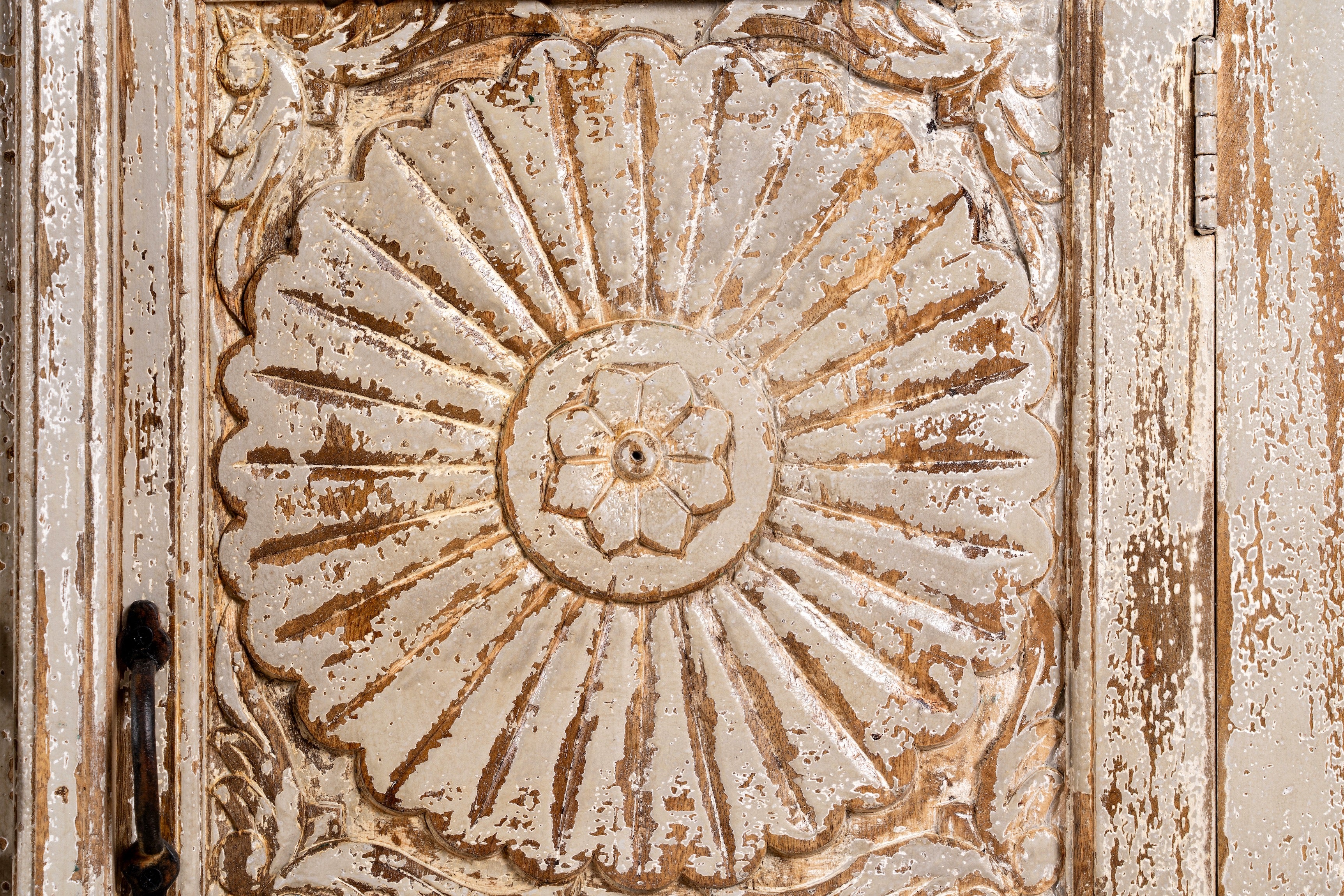 Close up image of a handcrafted carved sideboard made from reclaimed wood with floral motifs and distressed finish; suitable as bedroom furniture, 180 × 40 × 100 cm.