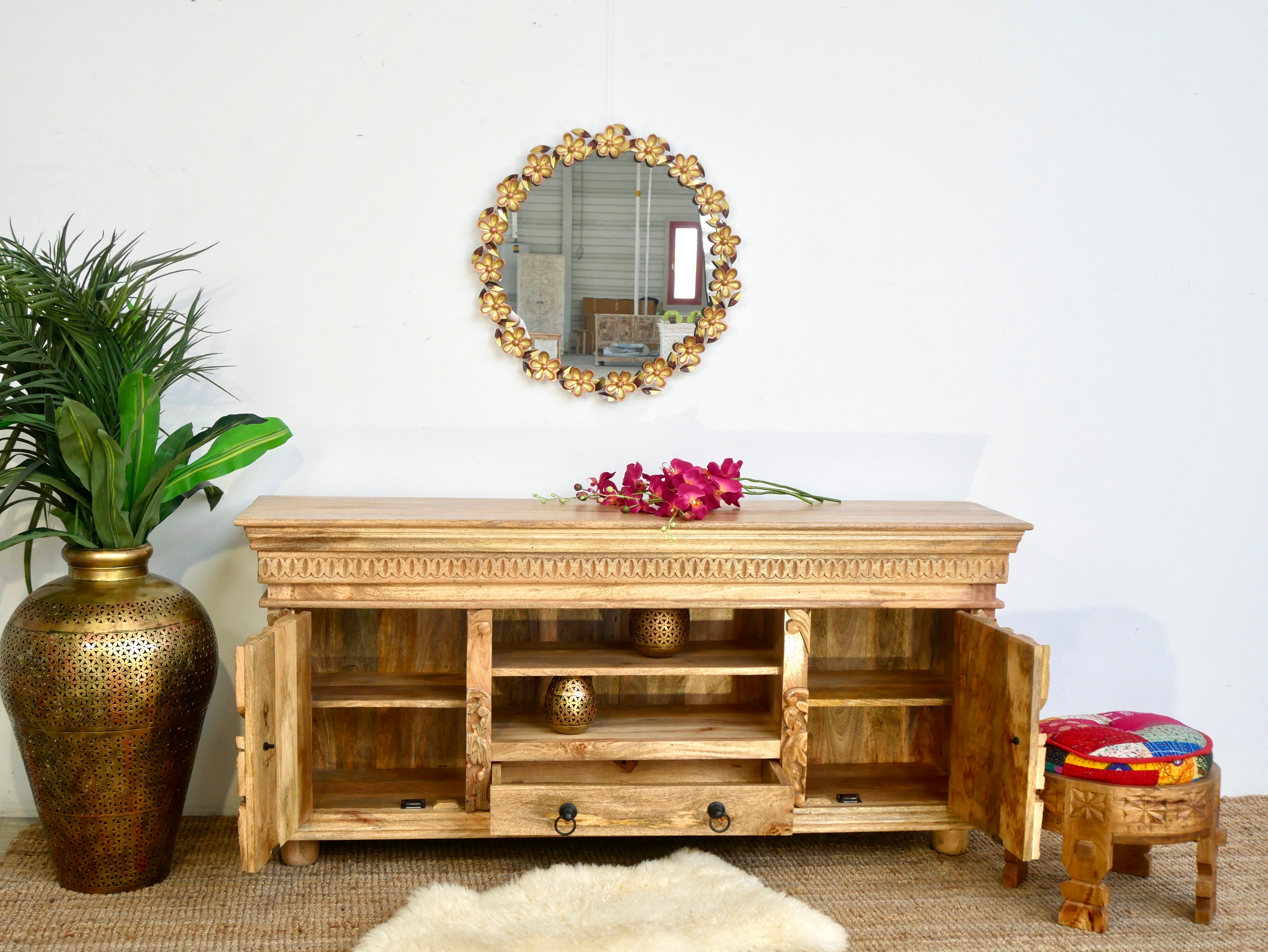 open door image of a hand-carved mango wood lowboard with two doors, one drawer, and open shelving; carved wooden sideboard for living or media room, 160 × 75 × 40 cm.