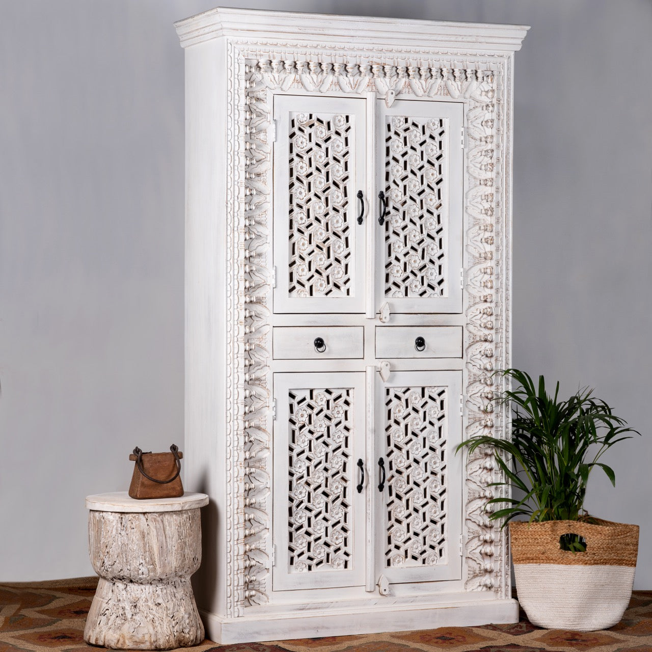 Side angle image of a hand-carved mango wood cabinet with shelving and whitewashed finish, bedroom furniture with floral and geometric motifs, 190 × 105 × 40 cm.
