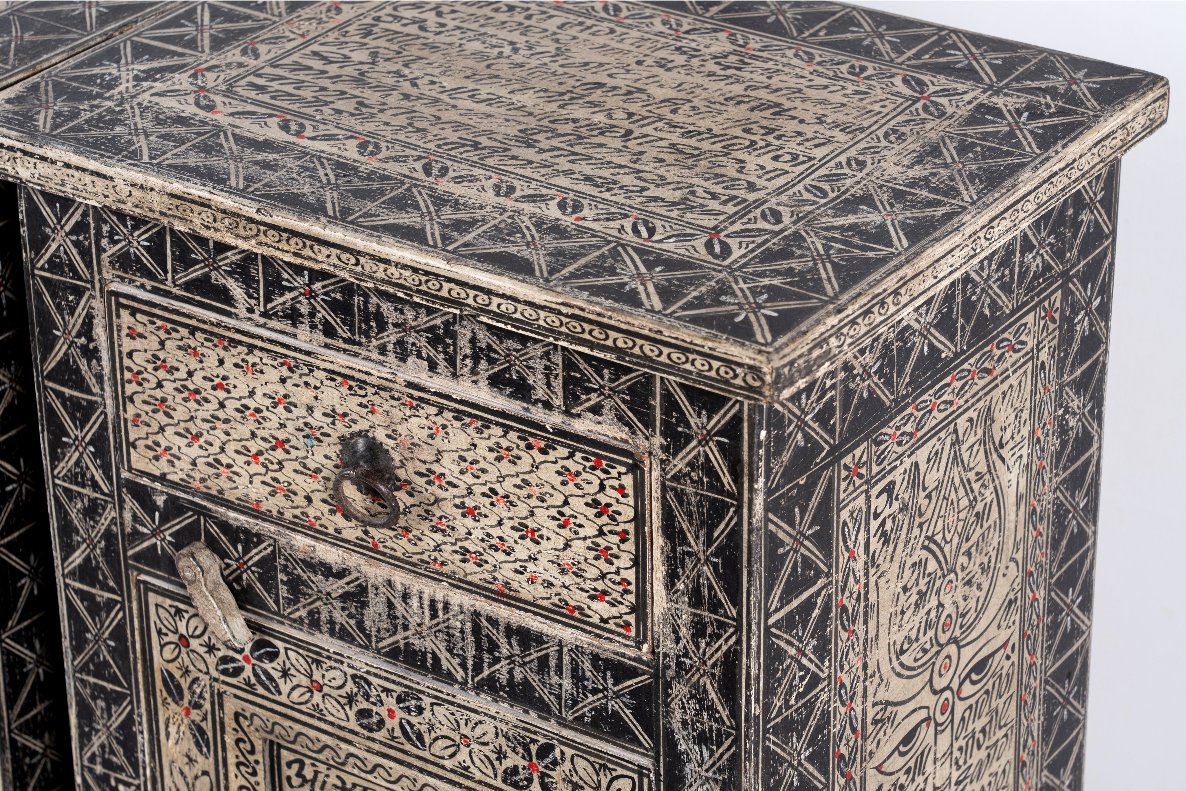 Close up image of a pair of hand painted Sanskrit bedside tables, reclaimed wood design inspired by traditional cupboards; sustainable furniture, 45 × 35 × 70 cm.