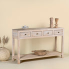 Side angle image of a sandblasted mango wood console table in Ibiza style with four drawers and lower shelf.