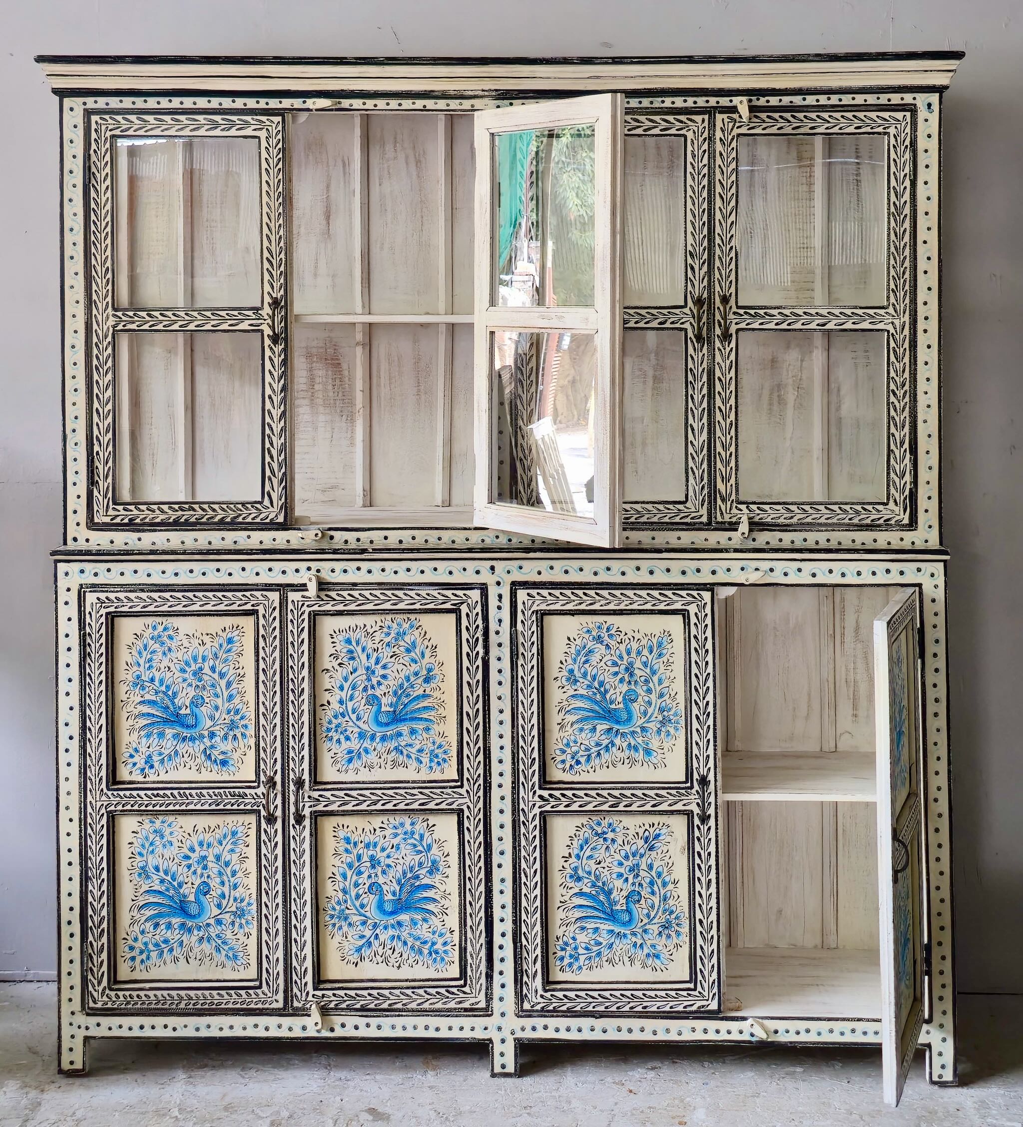 Image showing open door of a hand-painted reclaimed wood display cabinet with glass doors and floral blue peacock design – Aadrika model by Om Home & Garden