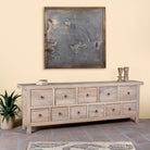 Side angle image of a reclaimed sandblasted wooden chest of drawers with 11 drawers, part of our Ibiza style furniture collection.