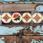 Close up image of a reclaimed teak wood display cabinet with light blue shabby chic finish and ceramic inlays – sustainable teak wood showcase with glass doors.