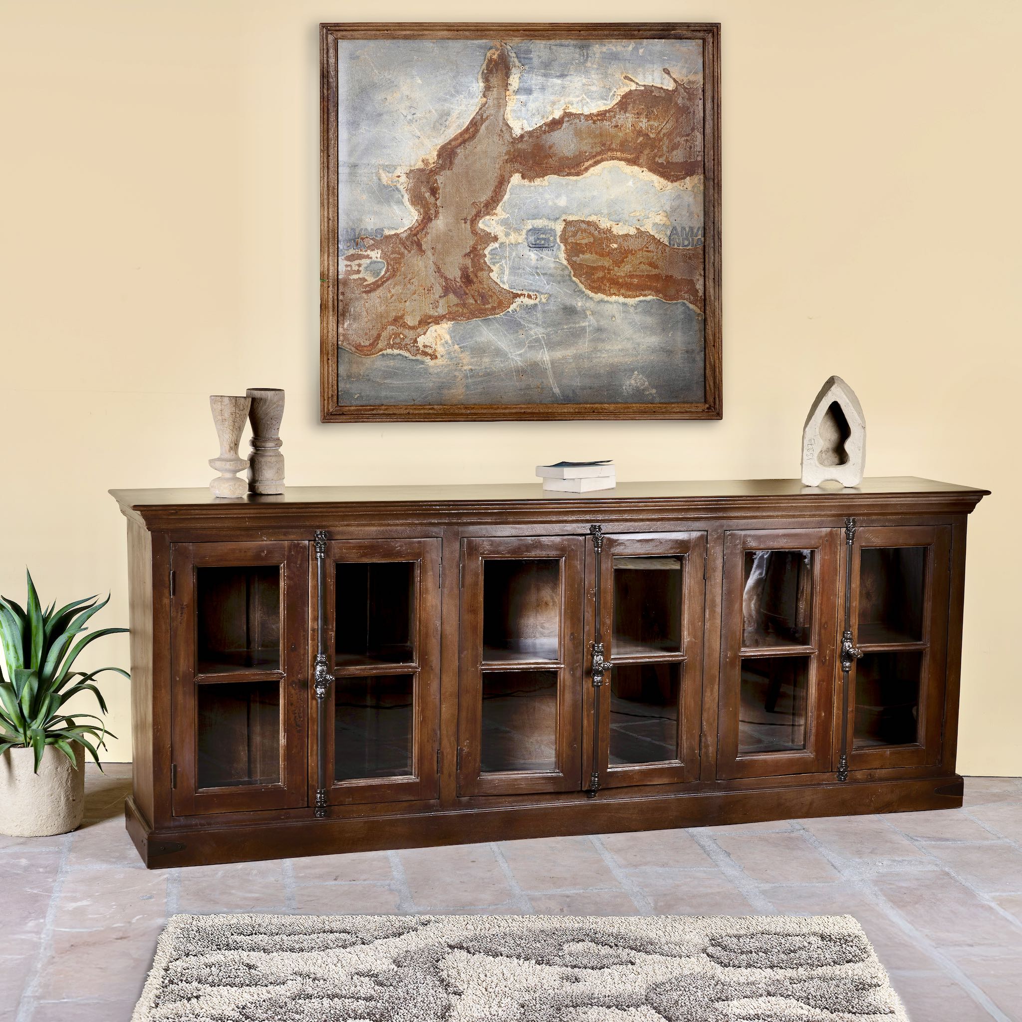 Side angle image of a large reclaimed wood sideboard in rustic boho style with six glass-panelled doors, 257×46×100 cm.