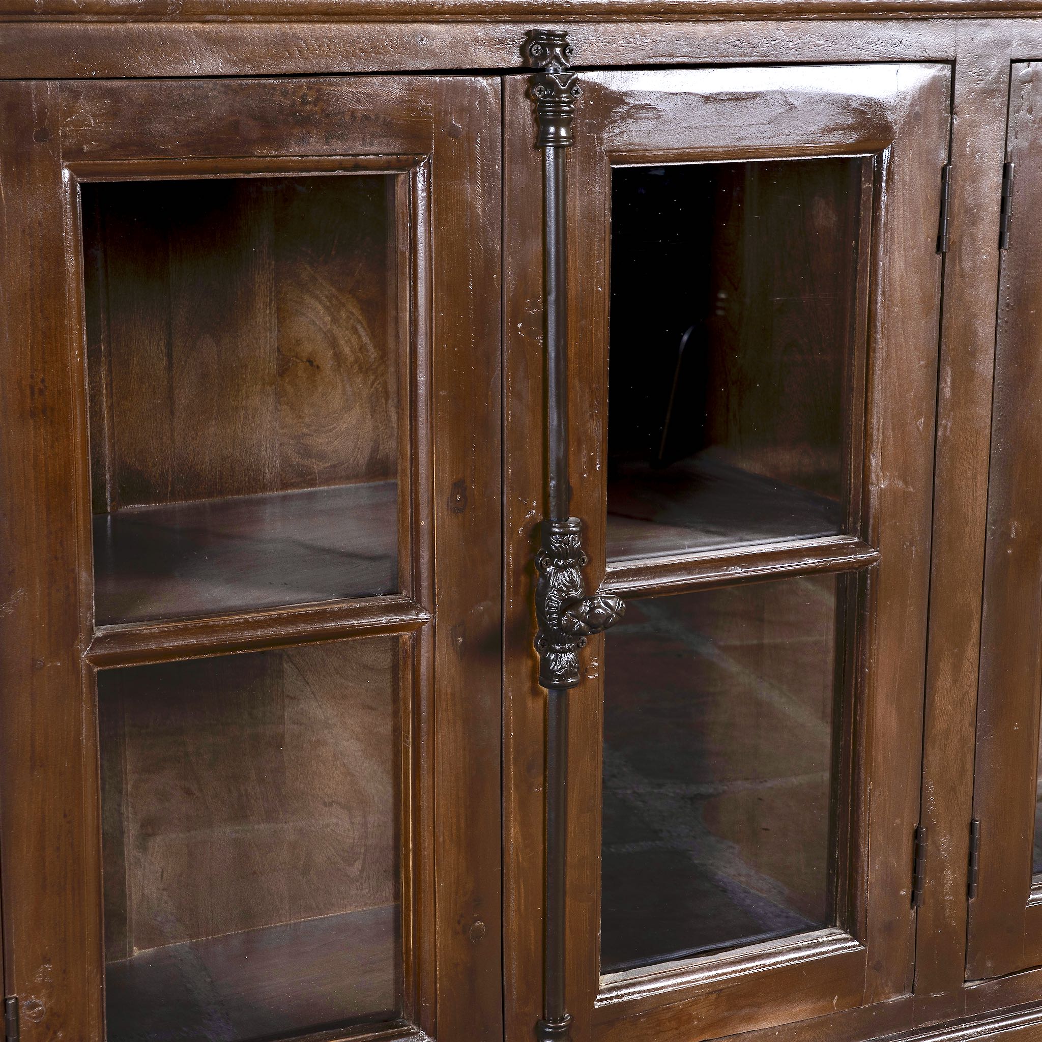 Close up image of a large reclaimed wood sideboard in rustic boho style with six glass-panelled doors, 257×46×100 cm.