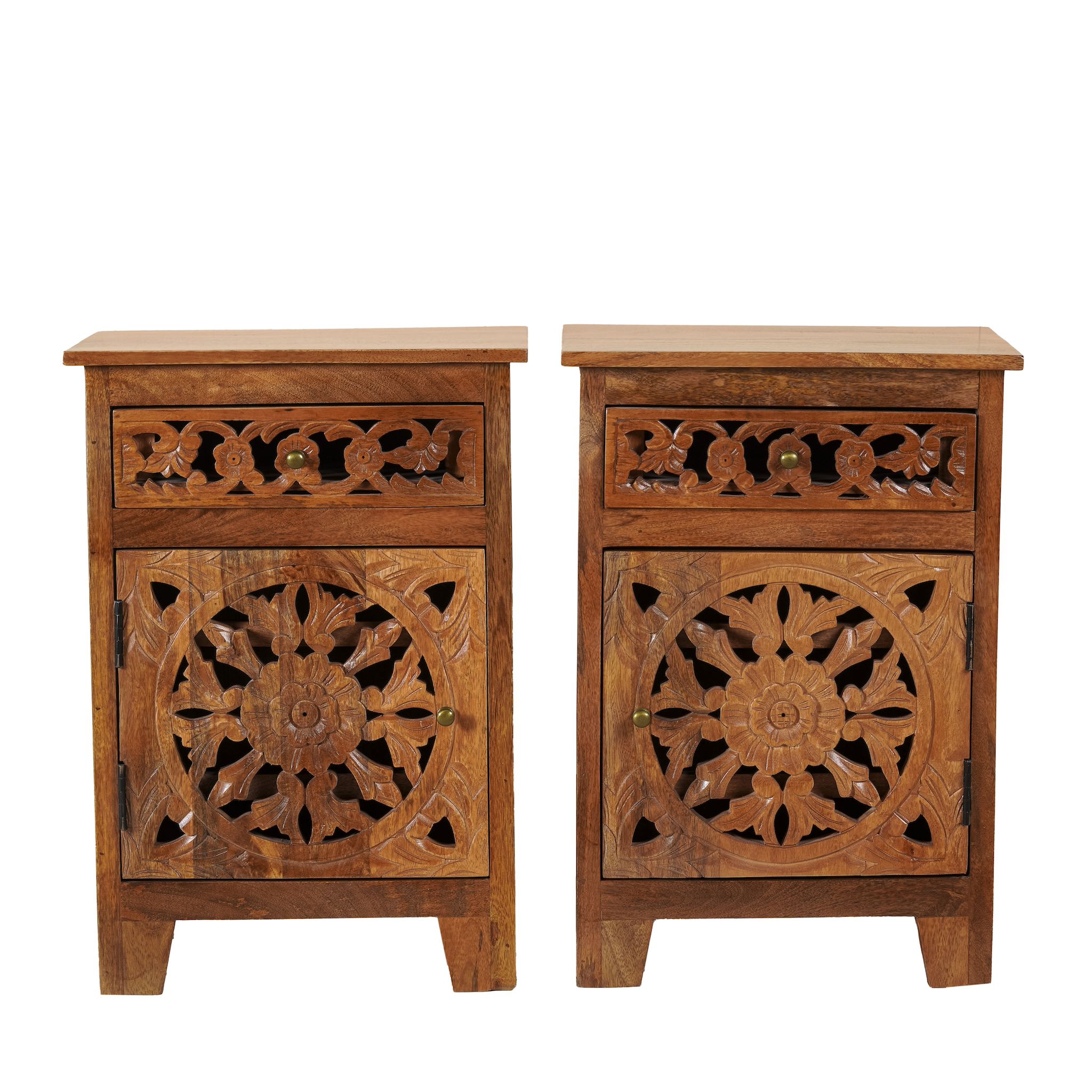 White background image of a pair of hand-carved bedside tables made of mango wood, featuring intricate round floral hand carvings on the doors. 