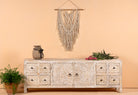 Ambalika hand carved lowboard in mango wood, a stylish mango wood TV unit with whitewashed floral design.