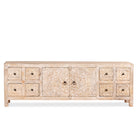 White background image of a hand carved lowboard in mango wood, a stylish mango wood TV unit with whitewashed floral design.