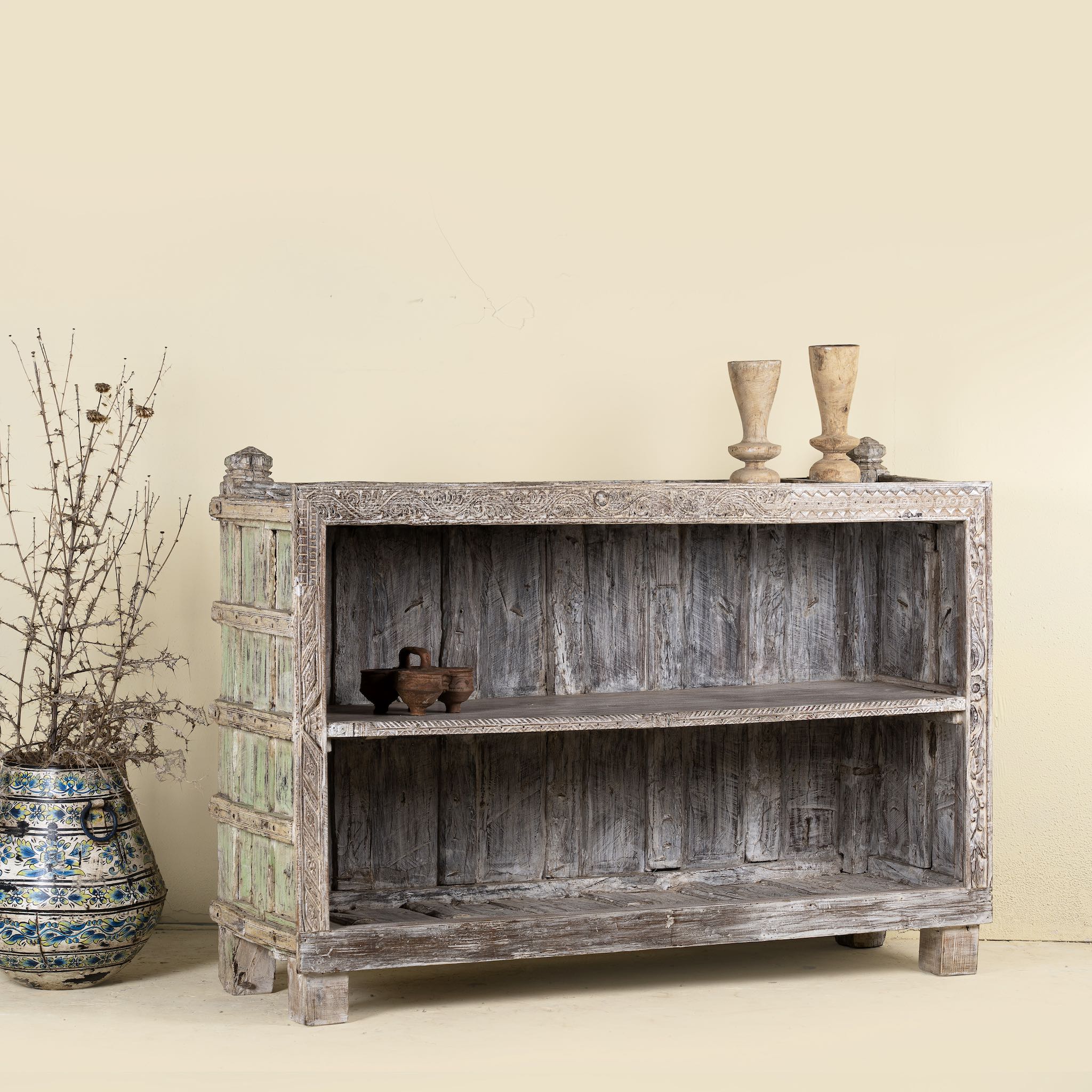 Back side image of an antique console table wood counter with open shelves, a one-of-a-kind teak piece of unique furniture.