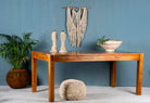 Side angle image of a rectangular solid wood dining table crafted from reclaimed teak; minimalist style reclaimed wood dining table, 180 × 100 × 77 cm.