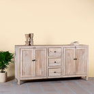 Side angle image of a sandblasted wood sideboard with drawers and cabinets, living room furniture in relaxed Ibiza style.