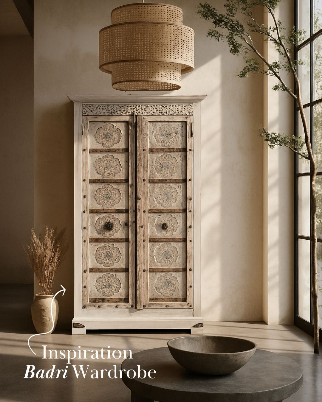 Living room scene of a old teak door wardrobe with floral carvings and original iron fittings.
