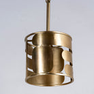 Side angle image of a medium round brass-plated metal pendant lamp with geometric cutout design – a modern take on vintage lights perfect for dining rooms, kitchens, or stylish living areas.