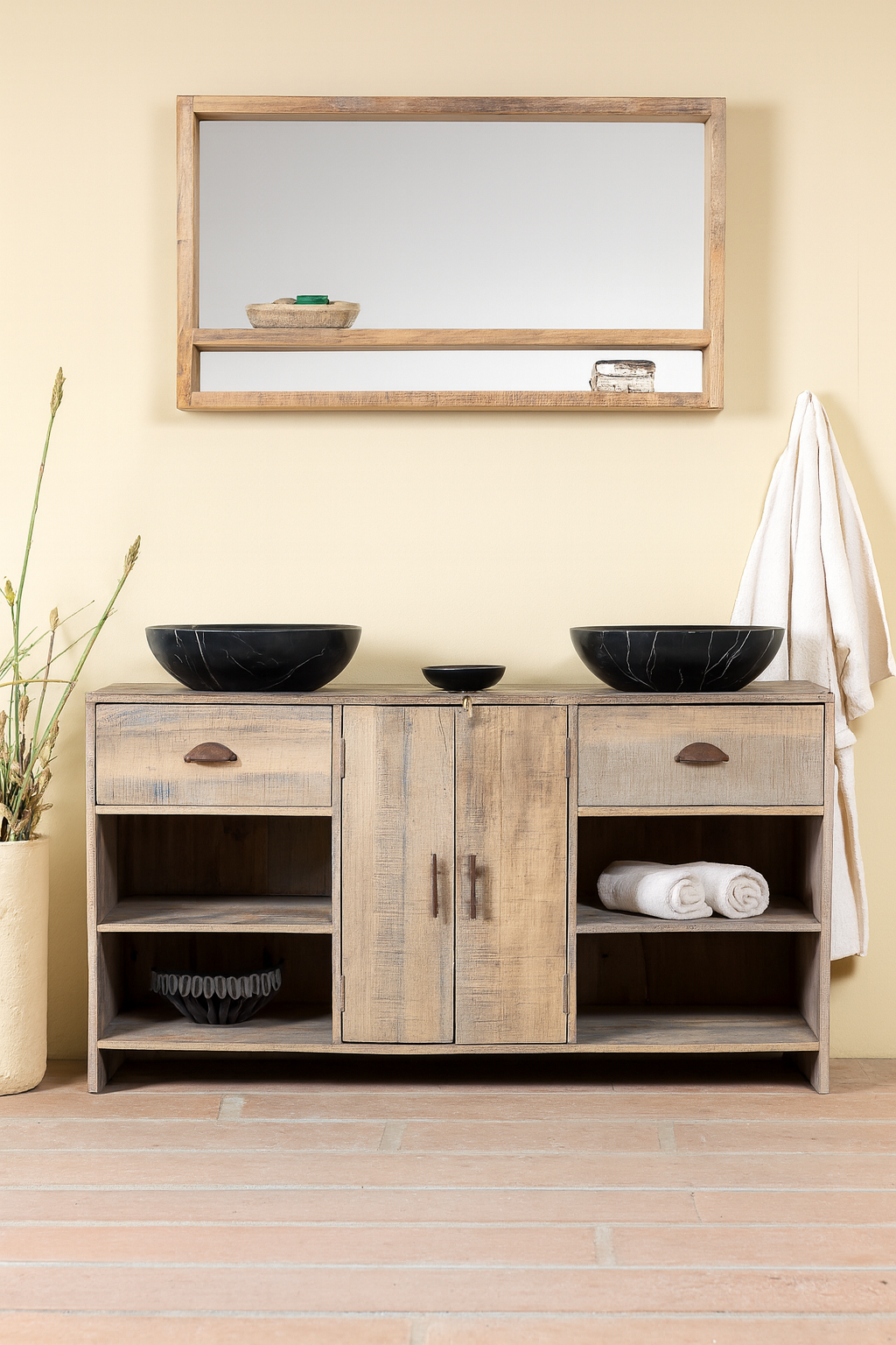 Wooden bathroom cabinet with mirrors, towels, and decorative items on a light wooden floor.