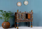 Side angle image with open door of a restored antique Indian Damchia chest crafted from teak wood with original paint, metal fittings, and mirror inlays—an authentic piece of unique Indian furniture for traditional or bohemian interiors.