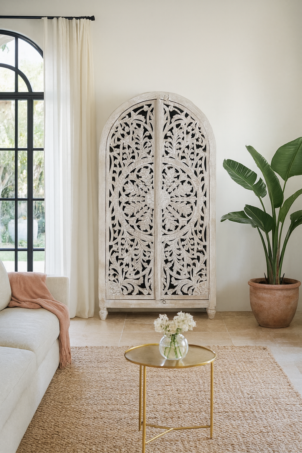 Lifestyle imagination of a of a Bhuvana arched mango wood wardrobe featuring a sculptural half-round design, intricate hand-carved floral detailing, and carved legs—an artisanal piece in the collection of arched wardrobes and mango wood wardrobes.