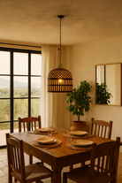 Lifestyle image of a Chahna rusted-style metal pendant light with hand-forged lattice and slatted design, suspended by an iron chain—an artisan piece from our collection of hand crafted metal lamps and compact metal pendant lights.