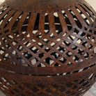 Close up image of a Champa hand crafted metal pendant light with spherical lattice design and iron chain—an artisan lighting piece from our collection of compact metal pendant lights and hand forged metal lamps.