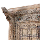 Close up picture of a one-of-a-kind Indian cabinet made from an old door, featuring intricate hand carvings and traditional craftsmanship in a vintage finish.
